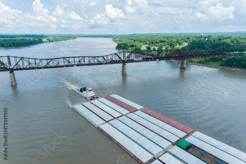 Barge on the Mississippi river and train crossing the Thebes bridge near Thebes, Illinois