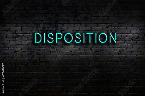Neon sign. Word disposition against brick wall. Night view