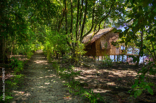 Waterfront thatched hut in the rainforests of Marovo Lagoon in the Solomon Islands.