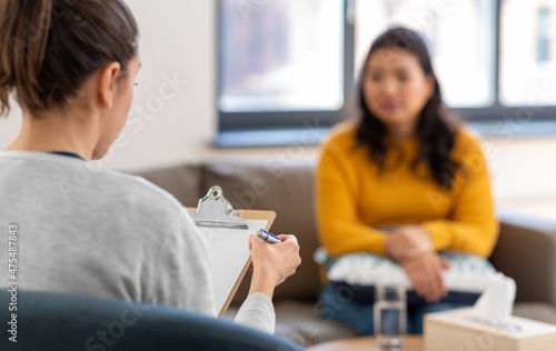 psychology, mental therapy and people concept - close up of woman psychologist and patient at psychotherapy session