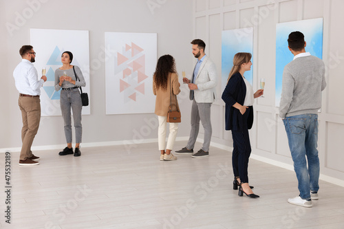 People viewing exposition in modern art gallery