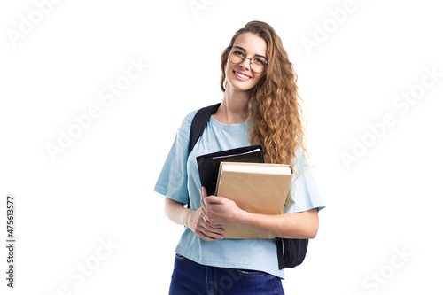 Young smiling student woman holds books while looking at camera. Over white background. Education.