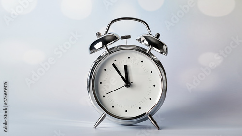  vintage alarm clock on a blurred bokeh background 