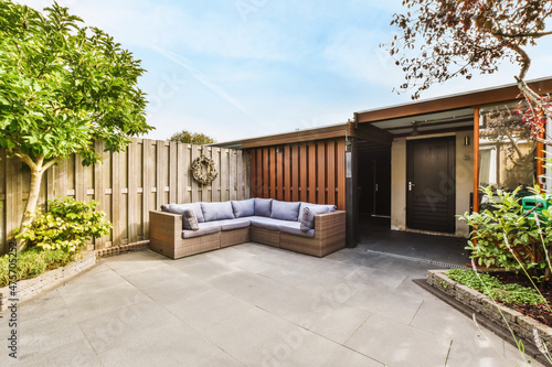 Amazing courtyard design with wicker sofas and lots of greenery