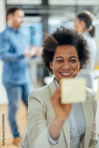 Picture of african-american woman, writing helpful tips for her colleagues.