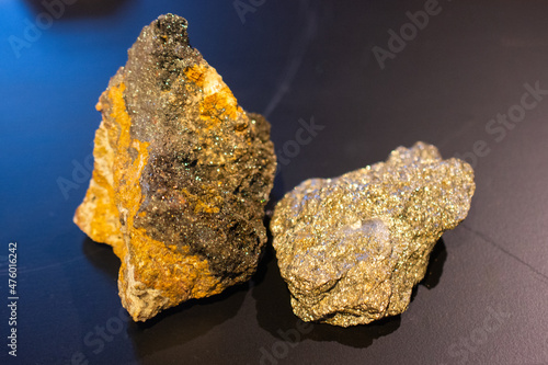 Pieces of magnetite mineral on a black surface