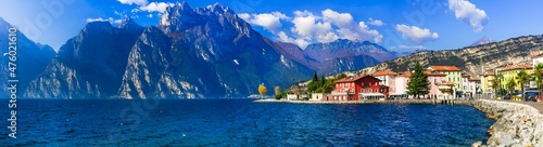 Beautiful lake Lago di Grada. Panoramic view of Torbole village with colorful houses amd high mountains . Italy, Trento
