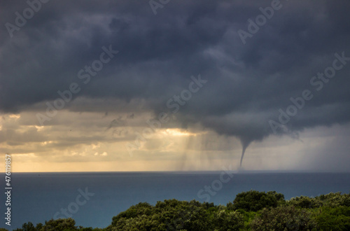 Tornadic waterspout on the sea on a stormy day