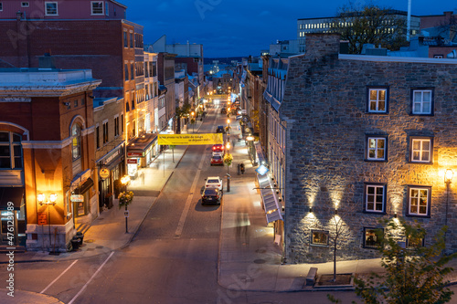 Quebec, Canada - October 18 2021 : Quebec City Old Town in autumn night. Restaurant and gift shop on Rue Saint-Jean.