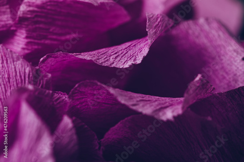 Fragment of a purple flower made of crepe paper. Macro photography. Soft selective focus