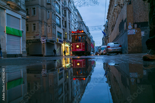 Old nostalgic tram going through the streets of European side of Istanbul. Vintage red tram in Taksim. winter landscape, snowy roads