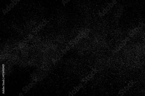 Distressed white grainy texture. Dust overlay textured. Grain noise particles. Snow effects pack. Rusted black background. Vector illustration, EPS 10. 