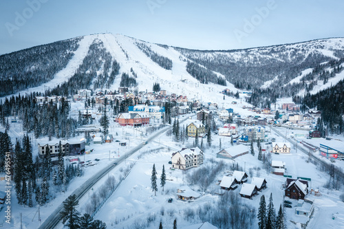 Winter landscape in Sheregesh ski resort in Russia, located in Mountain Shoriya, Siberia. Top view of Mount Zelenaya, hotels and restaurants of the resort