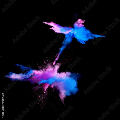 Bizarre forms of blue and pink powder paint explode in front of a black background to give off fantastic colors and forms.