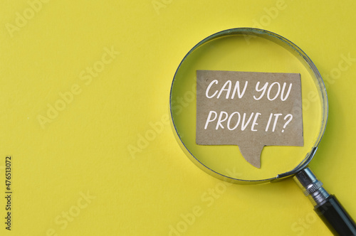 Magnifying glass and memo note with question CAN YOU PROVE IT?