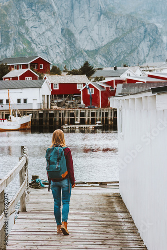 Traveler woman walking in Norway sightseeing Lofoten islands village Travel lifestyle outdoor summer vacations scandinavian trip