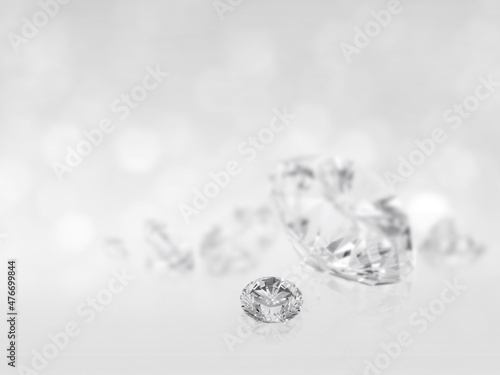 There are still expensive cut diamonds in front of the white background reflecting on the ground, lots of copying.