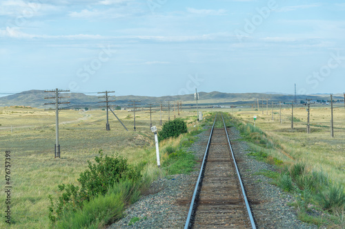 railway, railroad, rail, elevated. steppe prairie veld. is a means of transportation and passengers of trucks moving on rails that are located on the rails of the Great Plains. Kazakhstan 