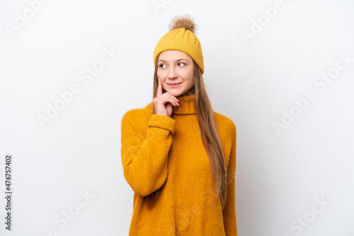 Young caucasian woman wearing winter jacket isolated on white background thinking an idea while looking up