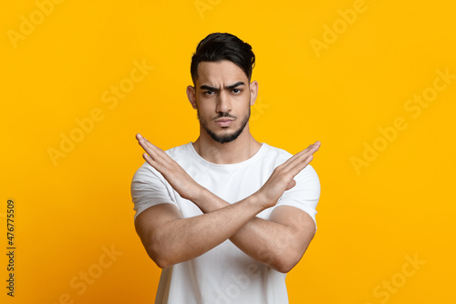 Serious arab guy showing stop or no gesture