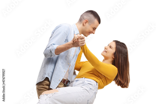 Happy casual young man and woman dancing tango