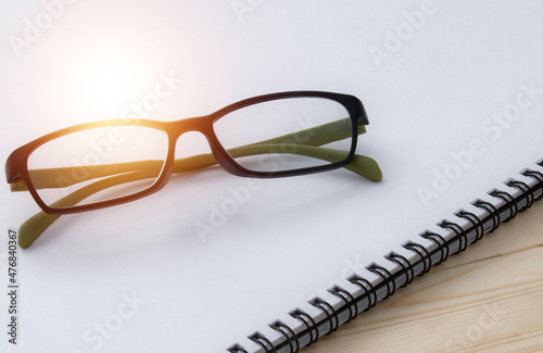 glasses on book , reading a book for the exam 