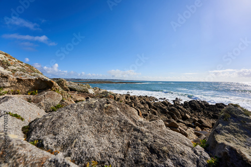 Rocks on the Breton coast. Landscape with sea water against blue sky. Rocky background. France, Brittany, Audierne, Lervily.