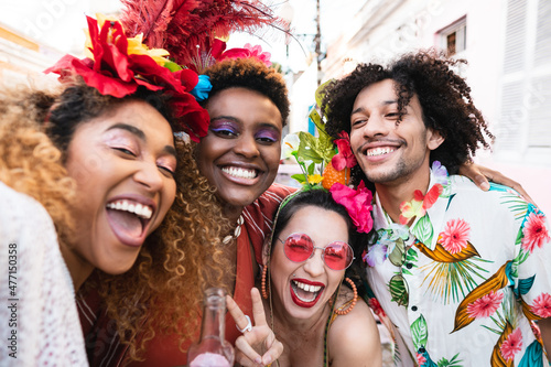 Woman and friends at street party Carnival in Brazil. People in costume celebrate Brazilian Carnaval during the day