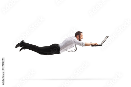 Professional man flying and working on a laptop computer