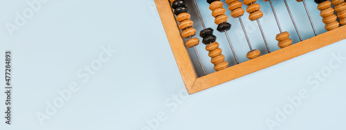 Wooden old abacus on a blue background. Flat lay and top view. Business or accounting concept