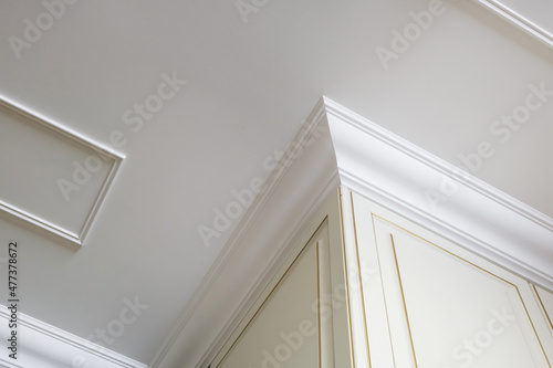 Detail of corner ceiling cornice with intricate crown molding.