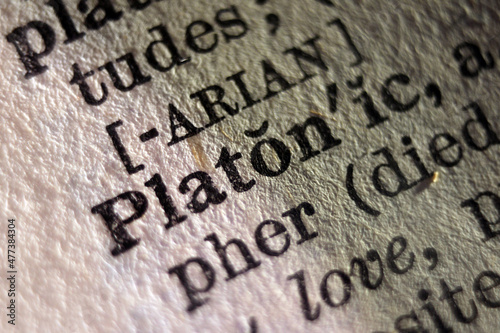 Word "Platon" printed on dictionary page, macro close-up 