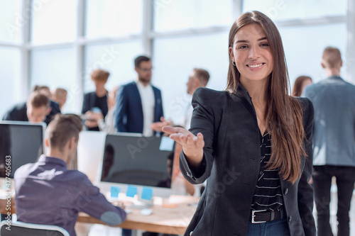 smiling friendly business woman on the background of the office.