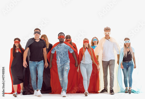 young people in colorful superhero cloaks standing together.