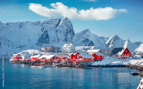 Attractive morning scene of Sakrisoy village, Norway, Europe. Bright winter view of Lofoten Islads witj typical red wooden houses. Beautiful seascape of Norwegian sea. Traveling concept background.