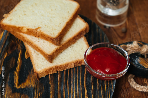 Toast bread on a wooden background. Meat sauce. Tomatoes.