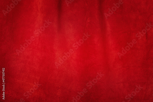 Red matte background of suede fabric, closeup. Texture of seamless leather.