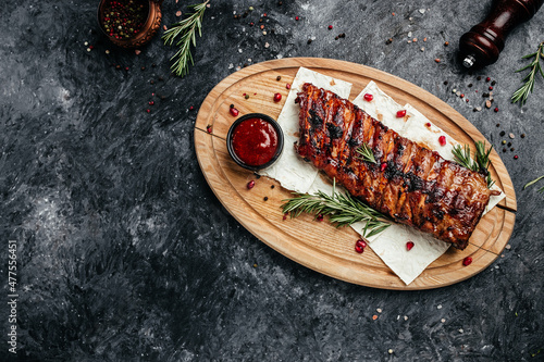 Spicy hot grilled spare ribs BBQ served on wooden cutting board, banner, menu, recipe place for text, top view