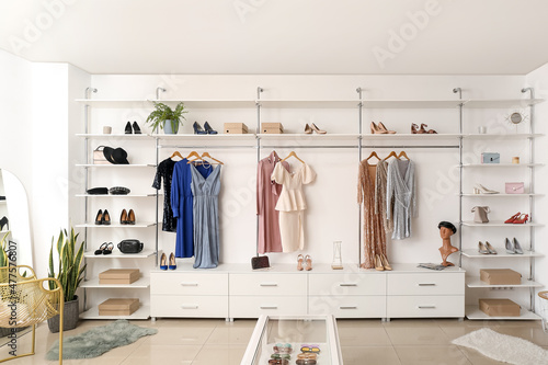 Interior of boutique with trendy clothes, shoes and accessories