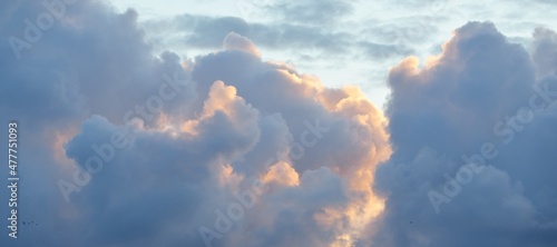 Clear blue sky with glowing pink and golden clouds after the storm. Dramatic sunset cloudscape. Concept art, meteorology, heaven, hope, peace. Graphic resources, picturesque panoramic scenery