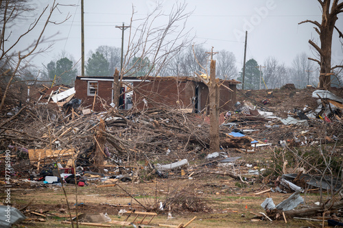 Destroyed neighborhood devastated by tornado with scattered debris