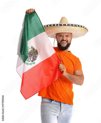 Emotional man in sombrero and with flag of Mexico on white background