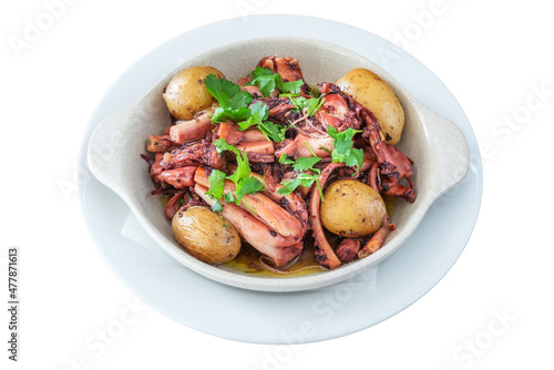Traditional Portuguese dish of octopus and potatoes called polvo a lagareiro close-up on a white plate