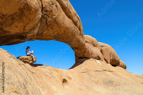 Woman hiker enjoying the rock archways of Spitzkoppe Namibia