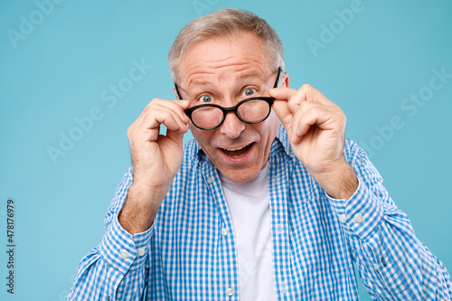 Surprised mature man in glasses staring at camera