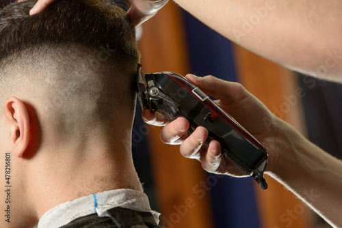Close up of hair clipper. Person getting a haircut