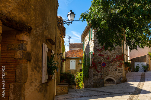 Picturesque landscape of Grimaud village overlooking typical narrow streets on warm sunny autumn day, France.