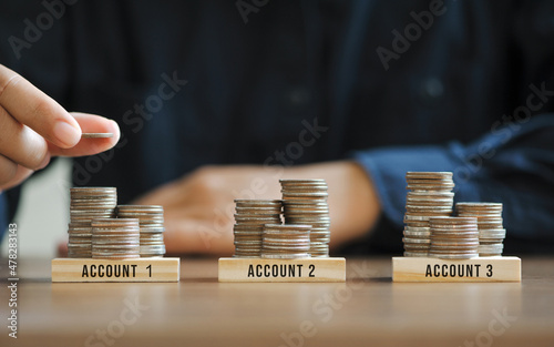 businessman hand stacking coins for finance investment management by portfolio diversification for distributing risks and increasing opportunities