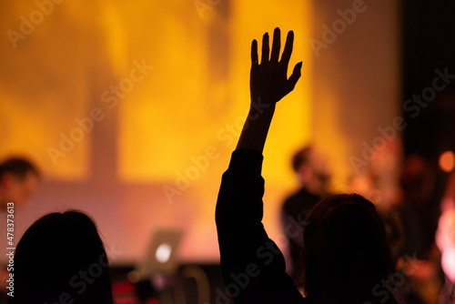 Hands in the air of people who praise God at church service