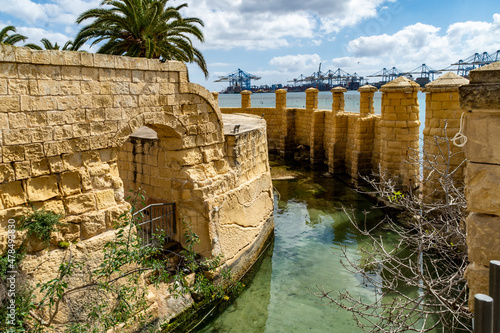 The moat around the Ferretti Battery built by the Order of Saint John in 1716. The Malta Freeport can be seen in the background.